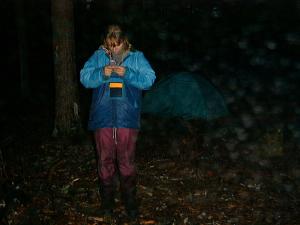 Катя ориентируется между палаткой и сосной. В руках у нее не компас, а мобильный телефон.
